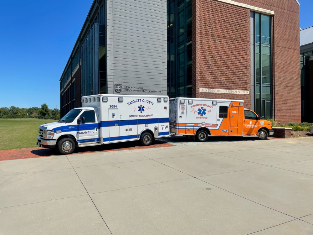 Two ambulance trucks parked back to back