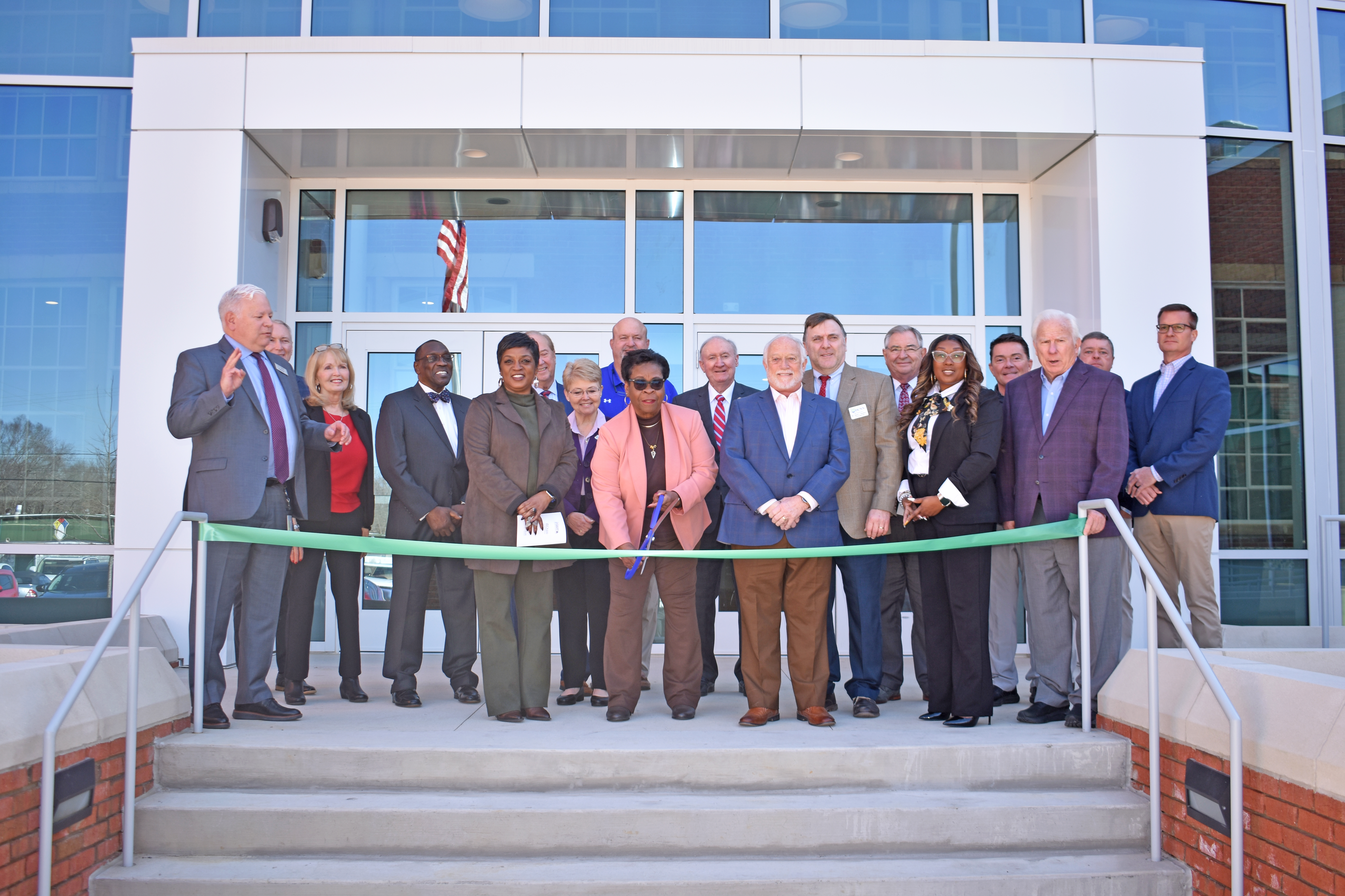 Group of leader standing in front of Harnett Advance Technology Center for ribbon cutting